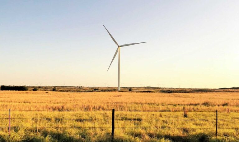 Windmill in field